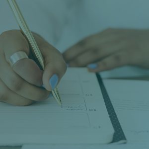 woman writing in planner